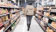 People shop at a grocery store in Montreal, Sunday, December 19, 2021, as the COVID-19 pandemic continues in Canada and around the world. THE CANADIAN PRESS/Graham Hughes 
