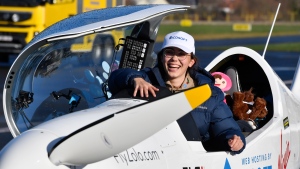 Belgium-British teenage pilot Zara Rutherford smiles as she gets out of the cockpit after landing her Shark ultralight plane at the Kortrijk airport in Kortrijk, Belgium, Thursday, Jan. 20, 2022. The 19-year-old Belgium-British pilot Zara Rutherford has set a world record as the youngest woman to fly solo around the world, touching her small airplane down in western Belgium on Thursday, 155 days after she departed. Rutherford will find herself in the Guinness World Records book after setting the mark that had been held by 30-year-old American aviator Shaesta Waiz since 2017. (AP Photo/Geert Vanden Wijngaert) 