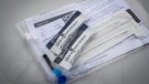 Two COVID-19 rapid tests that were given to a motorist are displayed at a Fraser Health drive-thru pick up site in Surrey, B.C., on Thursday, January 20, 2022. THE CANADIAN PRESS/Darryl Dyck
