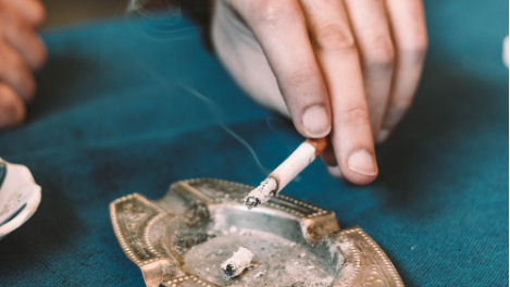 A person ashes a cigarette in this undated stock image (Pexels/Levent Simsek)