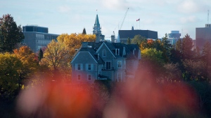The Canadian prime ministers' residence, 24 Sussex, is seen on the banks of the Ottawa River in Ottawa on Monday, Oct. 26, 2015. The Parliament Hill Peace Tower is in the distance. THE CANADIAN PRESS/Sean Kilpatrick 