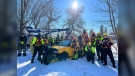 Crews from the Ottawa Police Service, Ottawa Paramedic Service and Ottawa Fire Service pose with the car they pulled from the Rideau River on Friday. (Dave Charbonneau/CTV News Ottawa)