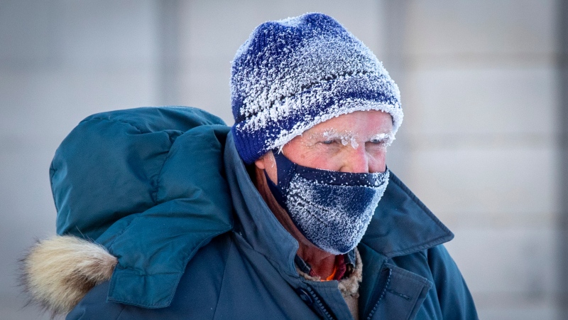 A man's face is covered with frost during a frigid cold morning in Kingston, Ont., on Friday, January 21, 2022. The temperature dipped below -35C with windchill. (Lars Hagberg/THE CANADIAN PRESS)
