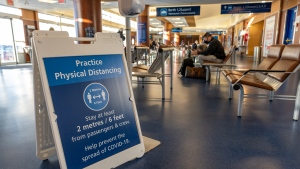 Sign promoting physical distancing during the COVID-19 pandemic at a BC Ferries terminal is seen in this undated image. (Shutterstock)