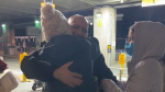 A family of Afghan refugees are reunited for the first time in four years outside Vancouver International Airport in December 2021.