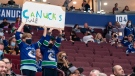 Vancouver Canucks fans cheer on their team as they take on the Winnipeg Jets in NHL preseason hockey action in Vancouver, Sunday, Oct. 3, 2021. THE CANADIAN PRESS/Richard Lam
