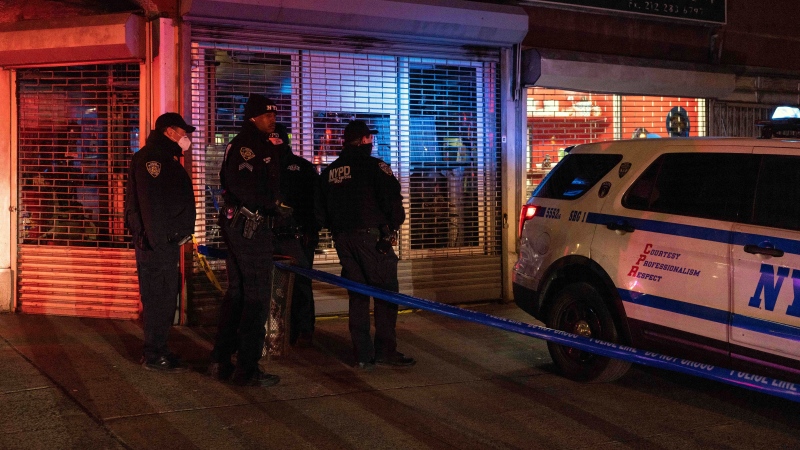 NYPD officers investigate the scene of a shooting in Harlem on Friday, Jan. 21, 2022, in New York. (AP Photo/Yuki Iwamura) 