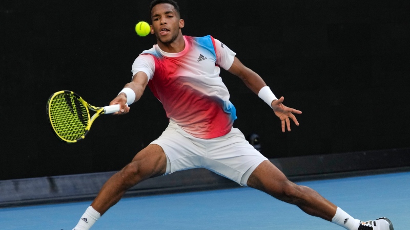 Felix Auger-Aliassime of Canada plays a forehand return to Daniel Evans of Britain during their third round match at the Australian Open tennis championships in Melbourne, Australia, Saturday, Jan. 22, 2022. (AP Photo/Simon Baker) 