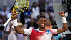 Felix Auger-Aliassime of Canada celebrates after defeating Daniel Evans of Britain during their third round match at the Australian Open tennis championships in Melbourne, Australia, Saturday, Jan. 22, 2022. (AP Photo/Simon Baker) 