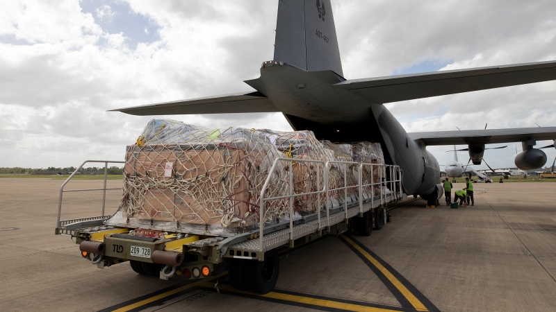 In this photo provided by the Australian Defence Force, a C-130J Hercules aircraft is loaded with humanitarian assistance and supplies at RAAF Base Amberley, Australia, Friday, Jan. 21, 2022, bound for Tonga after a volcanic eruption. (LACW Kate Czerny/Australian Defence Force via AP) 