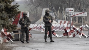 Ukrainian soldiers stand on a check-point close to the line of separation from pro-Russian rebels, Mariupol, Donetsk region, Ukraine, Friday, Jan. 21, 2022. (AP Photo/Andriy Dubchak)