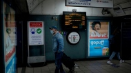 A sign is displayed telling people they must wear face coverings on Transport for London services and stations, in Euston underground train station, London, Friday, Jan. 21, 2022. (AP Photo/Matt Dunham) 