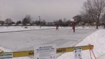 Dylan Wilkins (L) and Tanner Ducharme pass the puck at the new community ice rink at East Lions Park in London, Ont.  The teenagers were testing the ice as part of a trial run on Saturday Jan 22, 2022, a day ahead of its scheduled opening. (Brent Lale/CTV London)