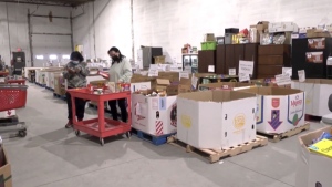 The Calgary Food Bank says it has plenty of donations, but not enough people to pack it up in hampers for clients.