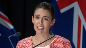 New Zealand Prime Minister Jacinda Ardern announces the country will move to red traffic light setting as part of new COVID-19 restrictions during a press conference in Wellington, Sunday, Jan. 23, 2022. (Mark Mitchell/New Zealand Herald via AP) 
