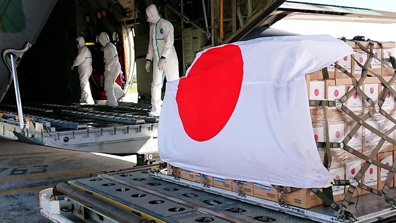 In this photo provided by Japan Joint Staff Office, a Japan Air Self-Defence Force aircraft arrives at Tonga's Fua'amotu International Airport, near Nuku'alofa, Saturday, Jan. 22, 2022 to deliver aid after an undersea volcano eruption. (Japan Joint Staff Office via AP) 