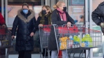 People leave a large box store in Montreal, Sunday, January 23, 2022, as the COVID-19 pandemic continues in Canada. In an effort to curb the spread of COVID-19, vaccine passports will be mandatory to enter the large box stores as of Monday. THE CANADIAN PRESS/Graham Hughes 