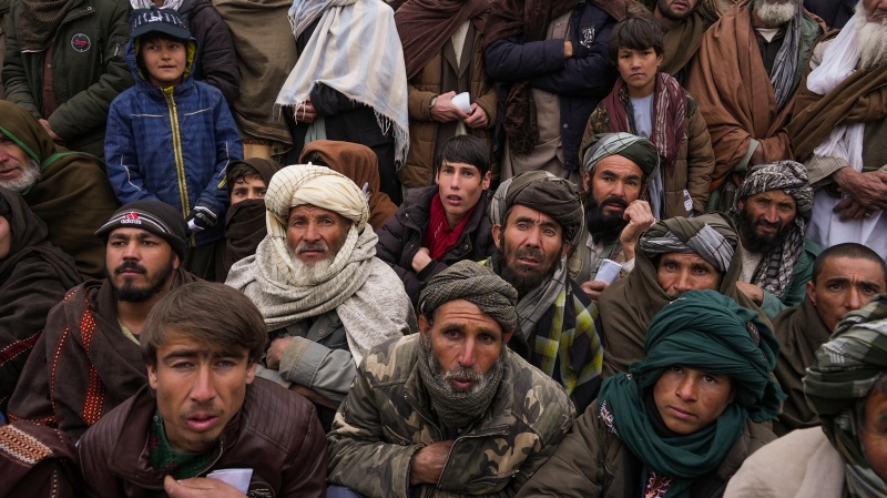 Afghan men gather to apply for humanitarian aid in Qala-e-Naw, Afghanistan, on Dec. 14, 2021. (AP Photo/Mstyslav Chernov)