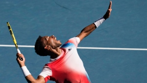 Felix Auger-Aliassime of Canada serves to Marin Cilic of Croatia during their fourth-round match at the Australian Open in Melbourne, Australia, on Jan. 24, 2022. (AP Photo/Simon Baker)