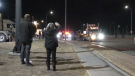 Anti-mandate convoy supporters wave to truckers in Calgary Sunday night.