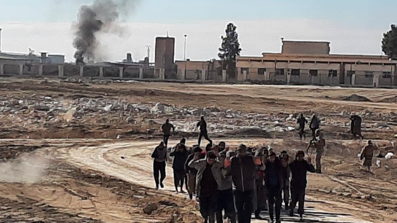 This photo provided by the Kurdish-led Syrian Democratic Forces, shows some Islamic State group fighters, who surrendered after clashing with Kurdish-led Syrian Democratic Forces, at Gweiran Prison, in Hassakeh, northeast Syria, on Jan. 24, 2022. (Kurdish-led Syrian Democratic Forces, via AP) 