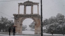 The snow-covered Hadrian's Arch during a snowfall in Athens, Greece, on Jan. 24, 2022. (Thanassis Stavrakis / AP)