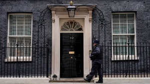 A Police officer walks outside 10 Downing Street in London on Jan. 24, 2022. (AP Photo/Alberto Pezzali) 