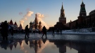 People in Red Square backdropped by the Spasskaya Tower, second right, and St. Basil's Cathedral, centre, in Moscow, Russia, on Dec. 28, 2021. (Alexander Zemlianichenko / AP)