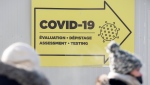 People are shown outside a COVID-19 testing site in Montreal, Saturday, January 15, 2022, as the pandemic continues in Canada. THE CANADIAN PRESS/Graham Hughes 