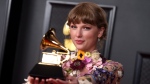Taylor Swift with her Grammy for album of the year for 'Folklore,' on March 14, 2021. (Jordan Strauss / Invision / AP) 