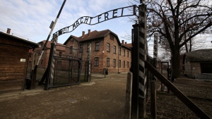 In this Jan. 27, 2020 file photo, writing reading in German "Work Sets You Free" is seen on the gate of the Auschwitz Nazi death camp in Oswiecim, Poland. (AP Photo/Markus Schreiber, file) ​