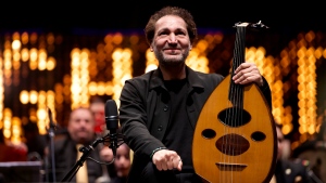 Iraqi virtuoso oud player Naseer Shamma prepares to perform with an orchestra at the Iraqi National Theatre in Baghdad, Iraq on Jan. 21, 2022. (AP Photo/Hadi Mizban) 