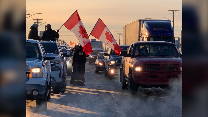 Supporters of the Freedom Convoy 2022 to Ottawa line up along the Trans-Canada Highway near Headingley, Man. on Jan. 25, 2022 (CTV News Photo)