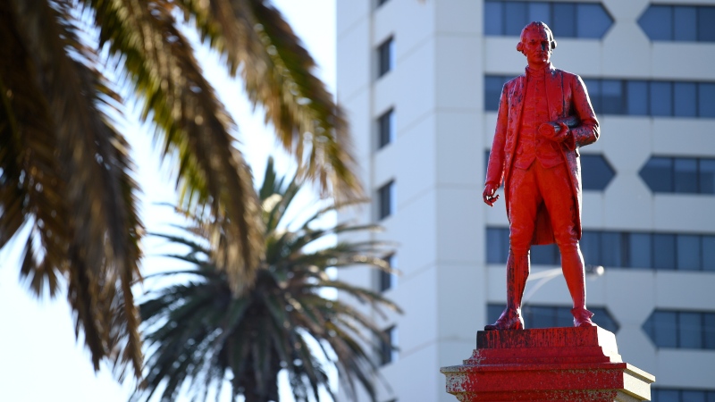 Red paint covers a statue of Captain James Cook after it was vandalized in Melbourne, Australia, Jan. 26. 2022. (James Ross/AAP Image via AP)