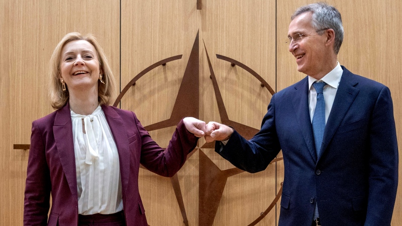 British Foreign Secretary Liz Truss, left, is greeted by NATO Secretary General Jens Stoltenberg prior to a meeting at NATO headquarters in Brussels on Jan. 24, 2022. (AP Photo/Olivier Matthys, Pool)