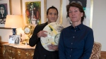 Marina Picasso, right, granddaughter of artist Pablo Picasso, and her son Florian Picasso pose with a ceramic art-work of Pablo Picasso in Cologny near in Geneva, Switzerland on Jan. 25, 2022.  (AP Photo/Boris Heger)