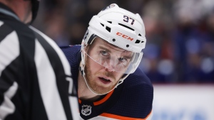 Edmonton Oilers' Connor McDavid lines up for a faceoff against the Vancouver Canucks during the third period of an NHL hockey game in Vancouver, on Tuesday, January 25, 2022. THE CANADIAN PRESS/Darryl Dyck 