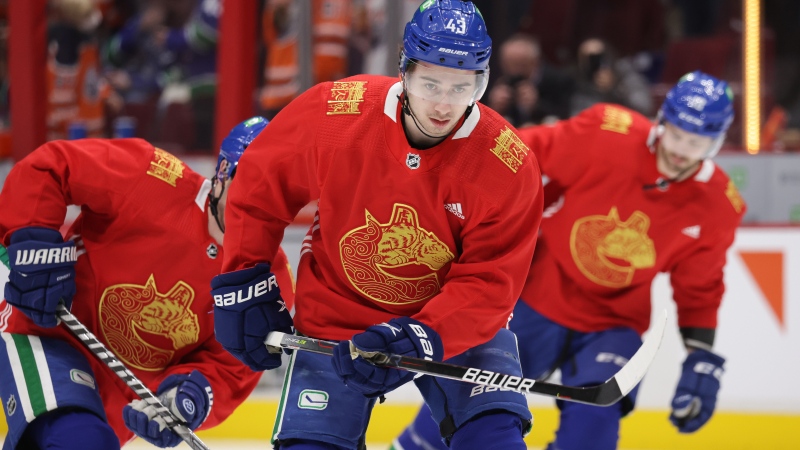 Vancouver Canucks' Quinn Hughes wears a special edition Lunar New Year jersey designed by local artist Trevor Lai during the pre-game skate before an NHL hockey game against the Edmonton Oilers in Vancouver, on Tuesday, Jan. 25, 2022. (Darryl Dyck / THE CANADIAN PRESS)