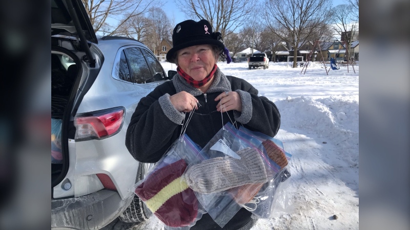 Donna Atkinson-Wilson holds just a few of hundreds of hand made winter wear items to be distributed in city parks and areas where those experiencing homelessness frequent, Jane. 26, 2022. (Sean Irvine / CTV London)