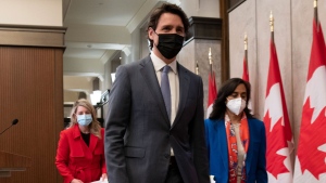 Prime Minister Justin Trudeau leaves a news conference with Foreign Affairs Minister Melanie Joly and Defence Minister Anita Anand following a cabinet retreat, Wednesday, Jan. 26, 2022 in Ottawa. CANADIAN PRESS/Adrian Wyld 
