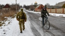 A Ukrainian serviceman patrols a street in Verkhnotoretske village in Yasynuvata district, Donetsk region, eastern Ukraine, on Jan. 22, 2022. (AP Photo/Andriy Andriyenko)