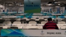 A journalist works in a media workroom at the main media centre at the 2022 Winter Olympics, on Jan. 25, 2022. (Jae C. Hong / AP)