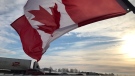A Canadian flag in front of transport trucks in Innisfil, Ont., on Thursday, Jan. 27, 2022 (Rob Cooper/CTV News)
