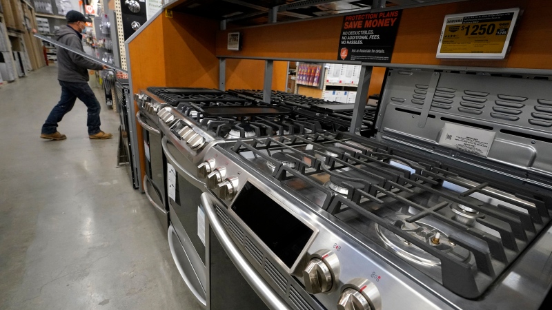In this Oct. 29, 2020 file photo, a passer-by walks past stoves on display at a Home Depot location, in Boston. (AP Photo/Steven Senne) 
