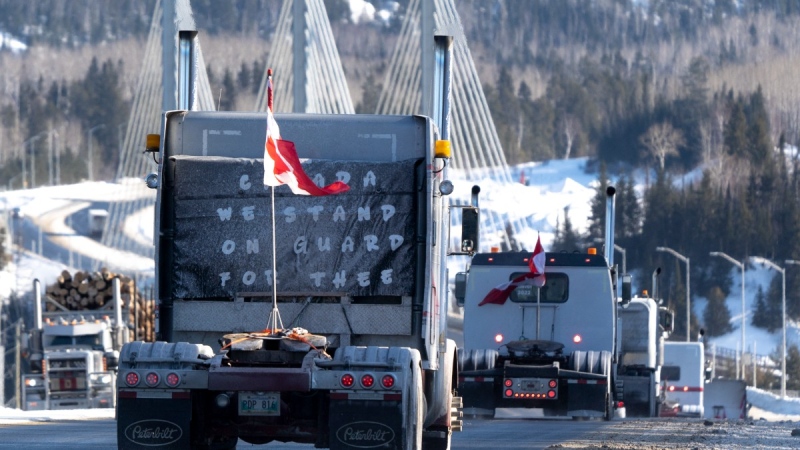 Protesters and supporters drive over the Nipigon Bridge on the Trans Canada Highway as part of a trucking convoy against COVID-19 vaccine mandates in Nipigon, Ont., Jan. 27, 2022. THE CANADIAN PRESS/David Jackson