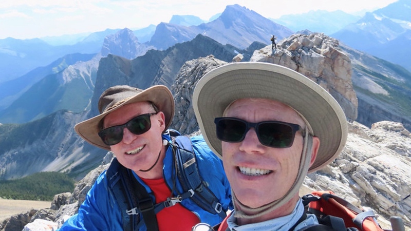 On July 10th, 2021 Ben Berg and Larry Welsman reached the top of Mount Lawrence Grassi and took a selfie. The couple climbed 65 mountain peaks last year