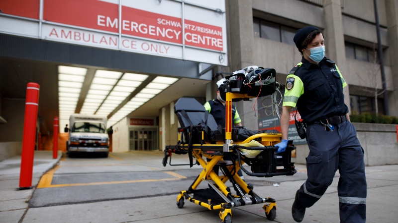 Paramedics wheel a gurney out from the emergency department at Mount Sinai Hospital in Toronto, Wednesday, Jan. 13, 2021. THE CANADIAN PRESS/Cole Burston 

