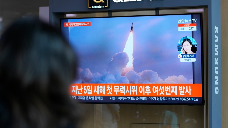 A woman watches a TV screen showing a news program reporting about North Korea's missile launch with a file image, at a train station in Seoul, South Korea, Thursday, Jan. 27, 2022. (AP Photo/Lee Jin-man) 