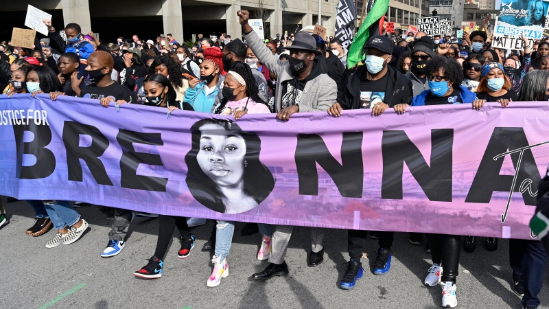 In this March 13, 2021 file photo, Tamika Palmer, centre, the mother of Breonna Taylor, leads a march through the streets of downtown Louisville, Ky., on the one year anniversary of Taylor's death. (AP Photo/Timothy D. Easley)