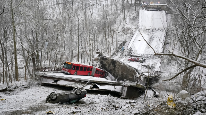 A Port Authority bus that was on a bridge when it collapsed Friday Jan. 28, 2022, is visible in Pittsburgh's East End. (AP Photo/Gene J. Puskar) 